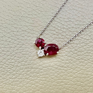 Timeless ruby and diamond necklace 2.72tcw, crafted with an oval ruby, round rubies, and diamonds, set in 14kt white gold. A one of a kind necklace for women by Treasured & Co., Astoria.