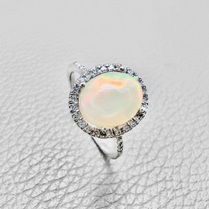 Oval opal diamond halo ring in 14kt white gold