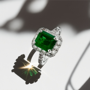 close-up of diamond halo totaling 0.75 ct around center emerald close-up of diamond halo totaling 0.75 ct around center emerald