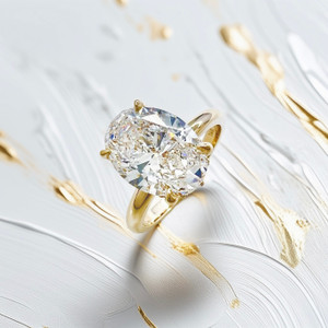 2.5 carat oval shaped lab diamond engagement ring with hidden halo in 14kt yellow gold photographed for Treasured And Co fine jewelry collection Astoria New York