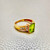 side view of diamonds from emerald cut peridot ring