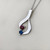 Heart pendant necklace featuring 0.60tcw blue topaz and garnet heart-shaped stones, elegantly set in 14kt white gold Treasured & Co.