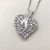Elegant 14kt white gold heart pendant necklace with a diamond cluster totaling 0.79tcw, perfect for timeless sophistication Treasured & Co.