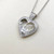 Stunning heart-shaped pendant necklace with 0.43tcw moving diamonds, crafted in luxurious 14kt white gold for timeless elegance Treasured & Co.