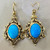 Oval turquoise drop earrings featuring 8.42tcw gemstones, crafted in 14kt yellow gold with an elegant vintage antiqued design Treasured & Co.