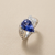 Tanzanite ring with diamonds, 1.69ct pear tanzanite and 0.10tcw diamond accents, angle view