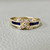 Unique X sapphire diamond ring with 0.25tcw, featuring a princess cut sapphire channel set with round diamonds forming an "X" design, set in 14kt yellow gold for women. A modern, sophisticated statement ring. Treasured & Co.