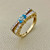 Unique 14kt yellow gold blue topaz diamond ring featuring 0.27tcw diamonds, designed with hearts on the bridge, perfect for a promise ring or stacking with other rings Treasured & Co.