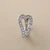 Heart statement ring in 14kt white gold, front view of open heart design with cubic zirconia pavé