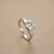 1.30tcw round-cut diamond engagement ring in three-stone setting — close-up detail