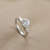 1.30tcw round-cut diamond engagement ring in three-stone setting — close-up detail (2)