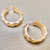 Stylish indent gold hoops 4.50g, made from 14kt yellow gold. Statement earrings for women by Treasured & Co., Astoria.