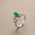 Oval emerald centre with diamond starburst halo 14kt white gold side angle