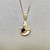 Charming wave pendant necklace 0.35-0.56tcw, featuring a Madagascar sapphire or cabochon opal in 14kt yellow gold. A unique, luxurious swirl design for women by Treasured & Co., Astoria.