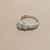 0.76tcw round-cut diamond engagement ring in with baguettes setting — detail shot