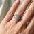 0.75tcw diamond engagement ring in cluster setting — on-hand modeled view