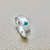 Emerald beveled edge band 14kt white gold angle view flush set stone