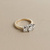 Three stone round cut diamond engagement ring high profile two tone 14kt gold side view