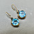 Luxury Swiss blue topaz drop earrings 12.50ct hexagonal cut yellow gold angle view