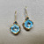 Blue topaz diamond earrings 14kt yellow gold front view blue white diamond accents