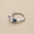 1.70tcw oval-cut sapphire engagement ring in three-stone setting — close-up detail