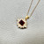 Side view of garnet And diamond halo pendant necklace