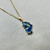 Overhead view of kite cluster London blue topaz necklace in gold