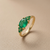 East-west oval emerald ring 18kt yellow gold horizontal centre setting