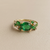 Emerald-cut tsavorite garnets framing oval emerald centre 18kt gold