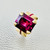 Emerald cut rhodolite garnet ring detail 14kt yellow gold Mozambique rubies