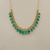 Front view of one-of-a-kind 10.46tcw emerald necklace in 18kt yellow gold