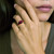 Garnet ring worn on model hand showing sparkle