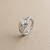 Round-cut diamond engagement ring in split-shank setting — three-quarter angle