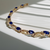 close-up of oval-cut sapphires and diamond accents on tennis bracelet