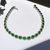 oval emerald and diamond tennis bracelet 14 kt white gold front view