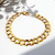 close-up high-polished Cuban link design on gold bracelet