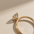 1.56tcw round-cut diamond engagement ring in solitaire setting in yellow gold — on-hand modeled view