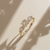 0.87tcw round-cut diamond engagement ring in three-stone setting — three-quarter angle (2)