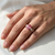 Padparadscha sapphire engagement ring 14kt rose gold worn on finger