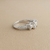Princess cut halo engagement ring white gold natural diamond three stone close-up