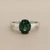 Green sapphire oval three stone ring 14kt white gold top view tapered baguette diamonds