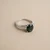 Green sapphire oval three stone ring 14kt white gold top flat view showing tapered baguette diamonds