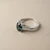 Oval green sapphire engagement ring three stone 14kt white gold baguette diamonds side profile