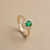Pear cut emerald ring with prong setting 14kt yellow gold close-up