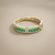 Emerald and diamond band 14kt yellow gold lifestyle shot natural light