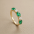 Five marquise-cut emeralds in 14kt yellow gold band top-down view