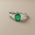 1.55tcw oval-cut emerald engagement ring in three-stone setting — front view