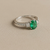 1.55tcw oval-cut emerald engagement ring in three-stone setting — side profile