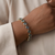 Iridescent mystic topaz stones in 14kt yellow gold bracelet close-up
