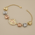 Virgin Mary butterfly charm bracelet 14kt yellow gold on wrist